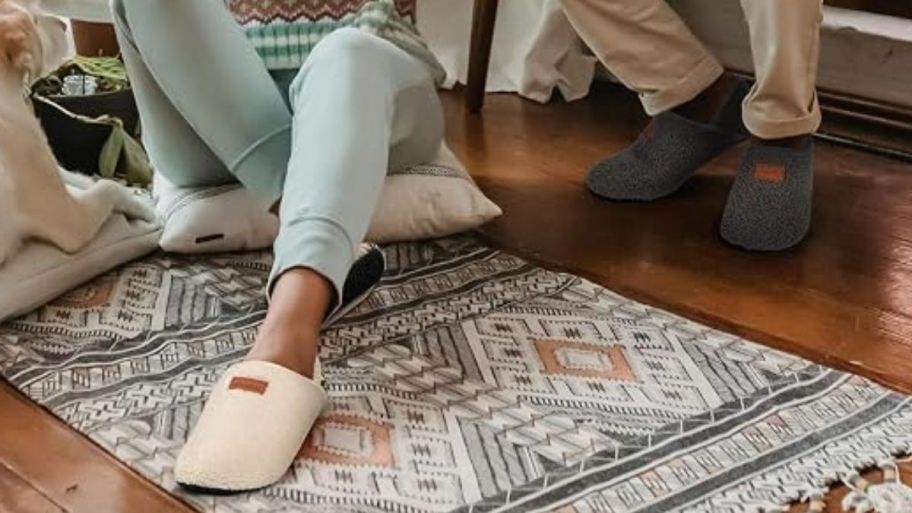 woman and man wearing slippers on the rug