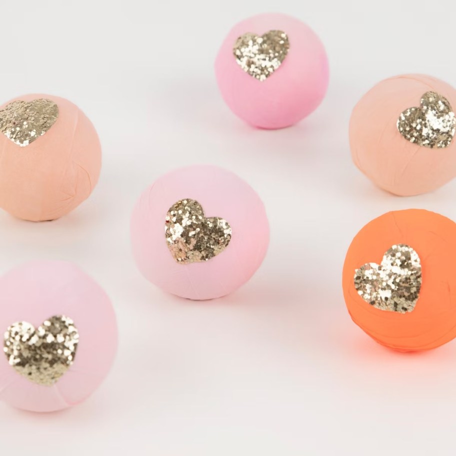 pink and orange balls with gold glitter hearts
