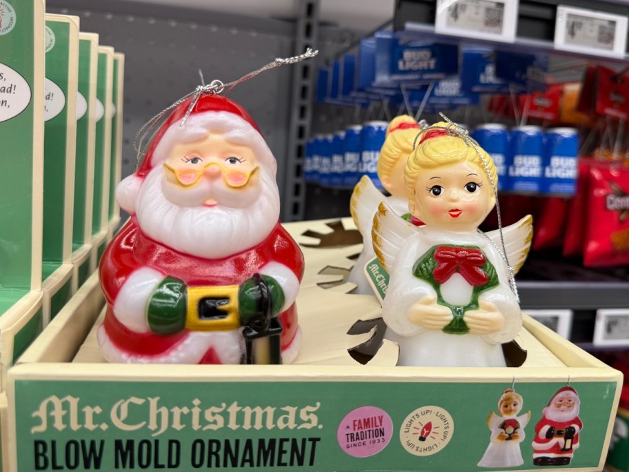 two blow mold Christmas ornaments in a green box