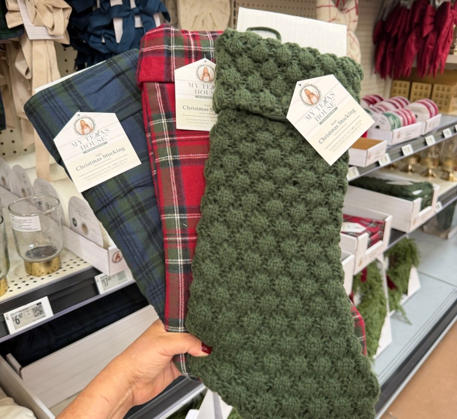 holding 3 christmas stockings