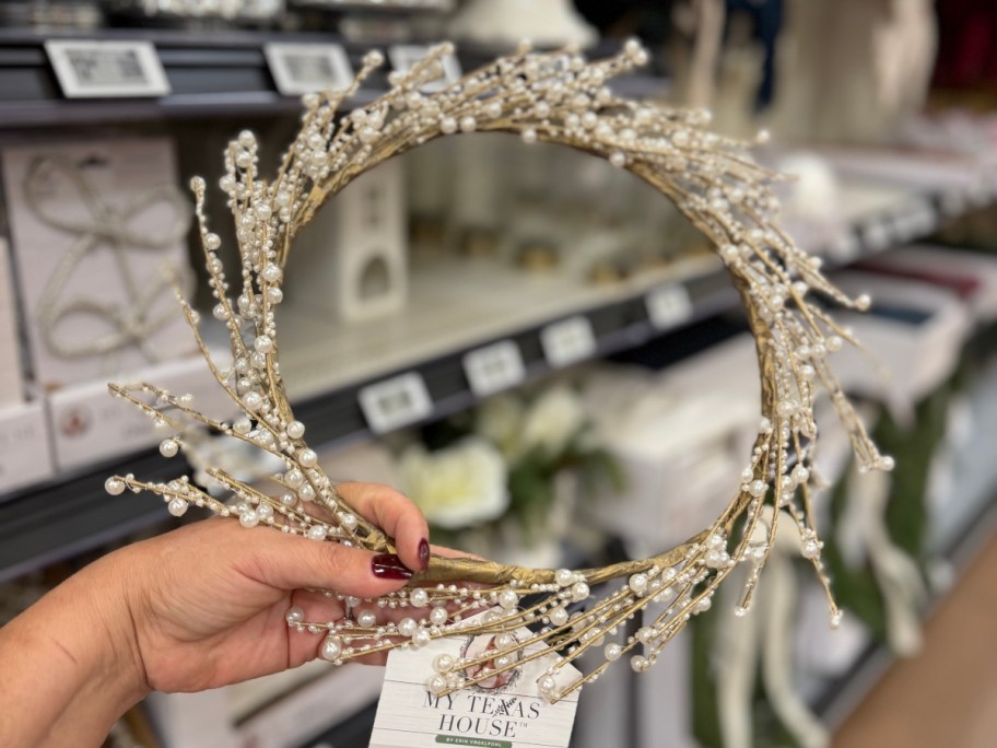 holding a pearl wreath