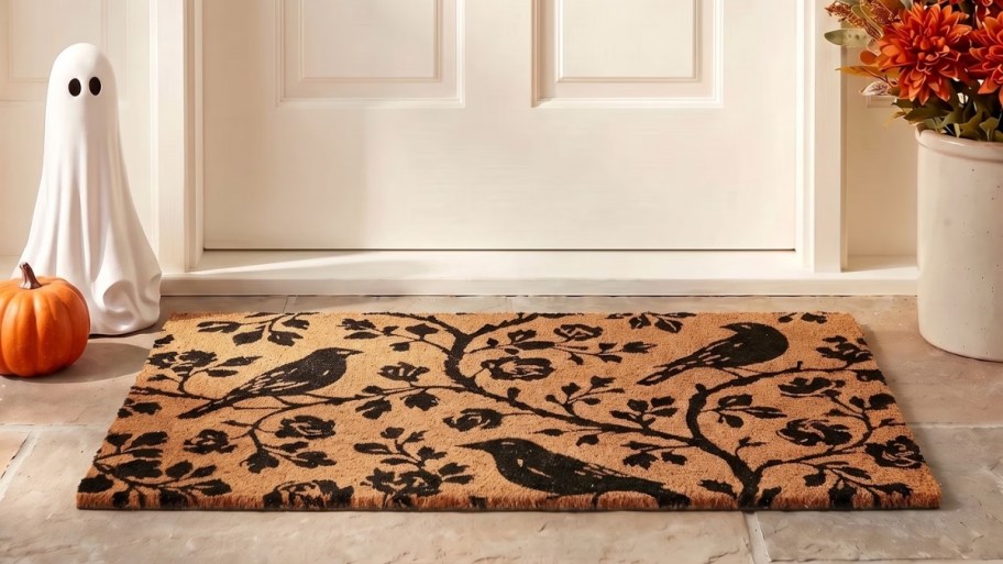 coir doormat with black bird and floral design