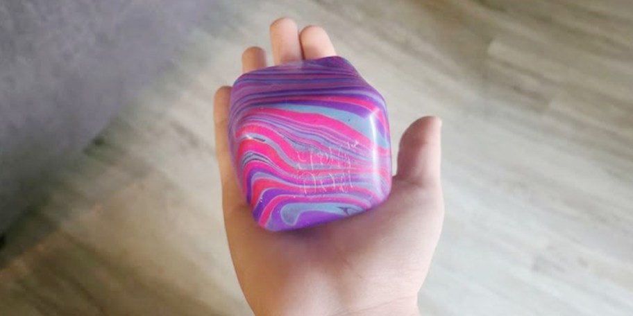 hand holding purple and pink needoh cube 