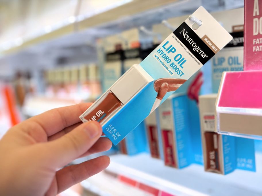 hand pulling a makeup item off a store shelf