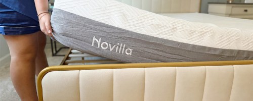woman putting mattress on bed
