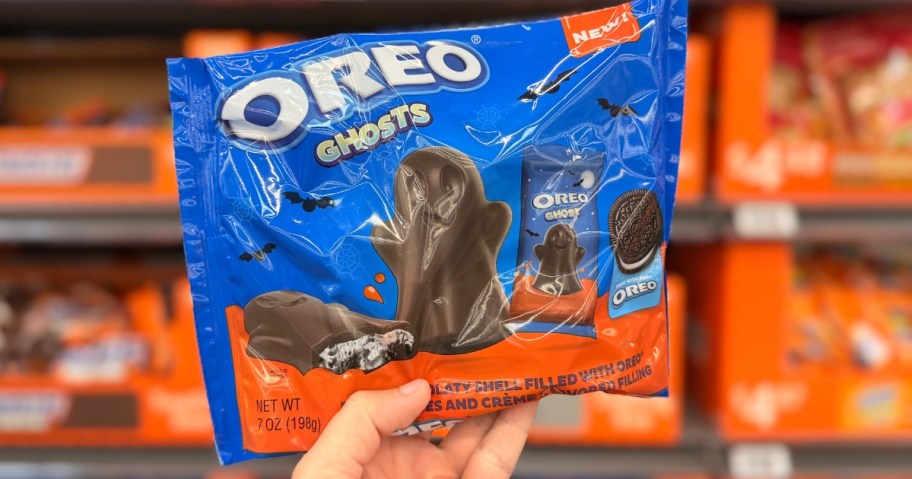 hand holding a bag of OREO Creme Filled Ghosts in a store aisle