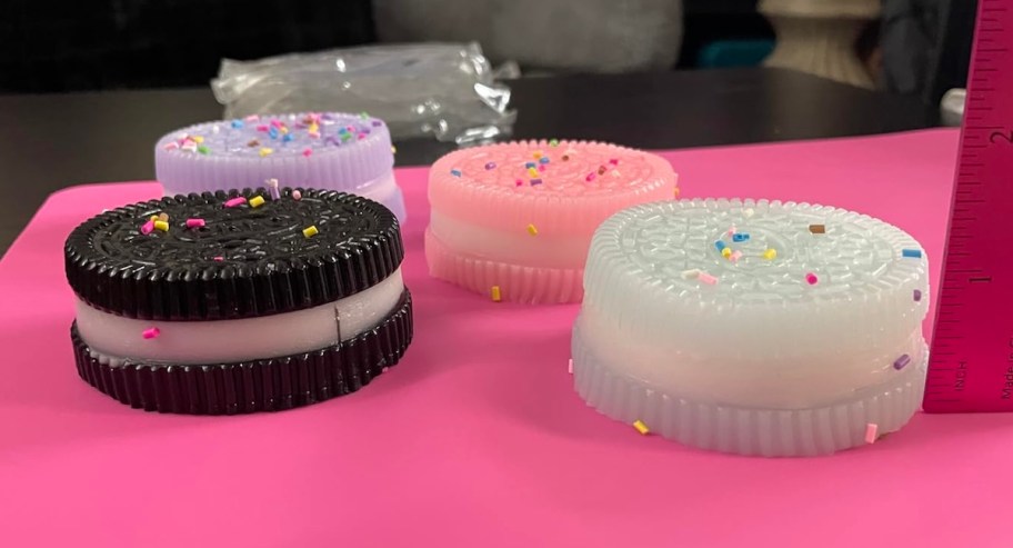 different color taba cookies with sprinkles on pink paper