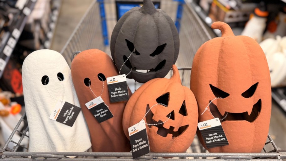 paper mache ghosts and pumpkins in a shopping carts