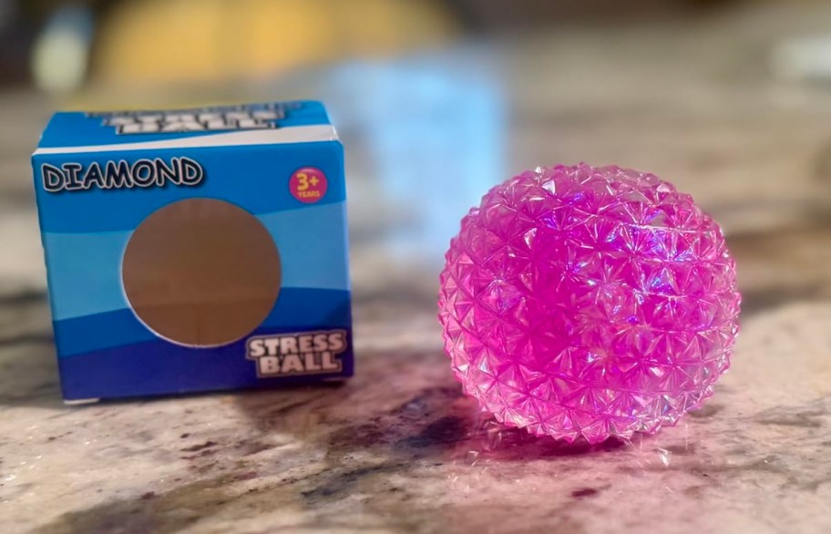 pink diamond stress ball with box on kitchen counter