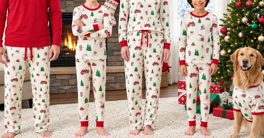 family in matching christmas pajamas standing next to a fireplace and christmas tree