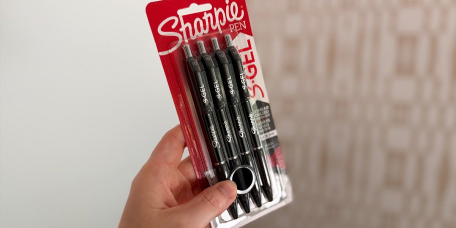 hand holding sharpie pens