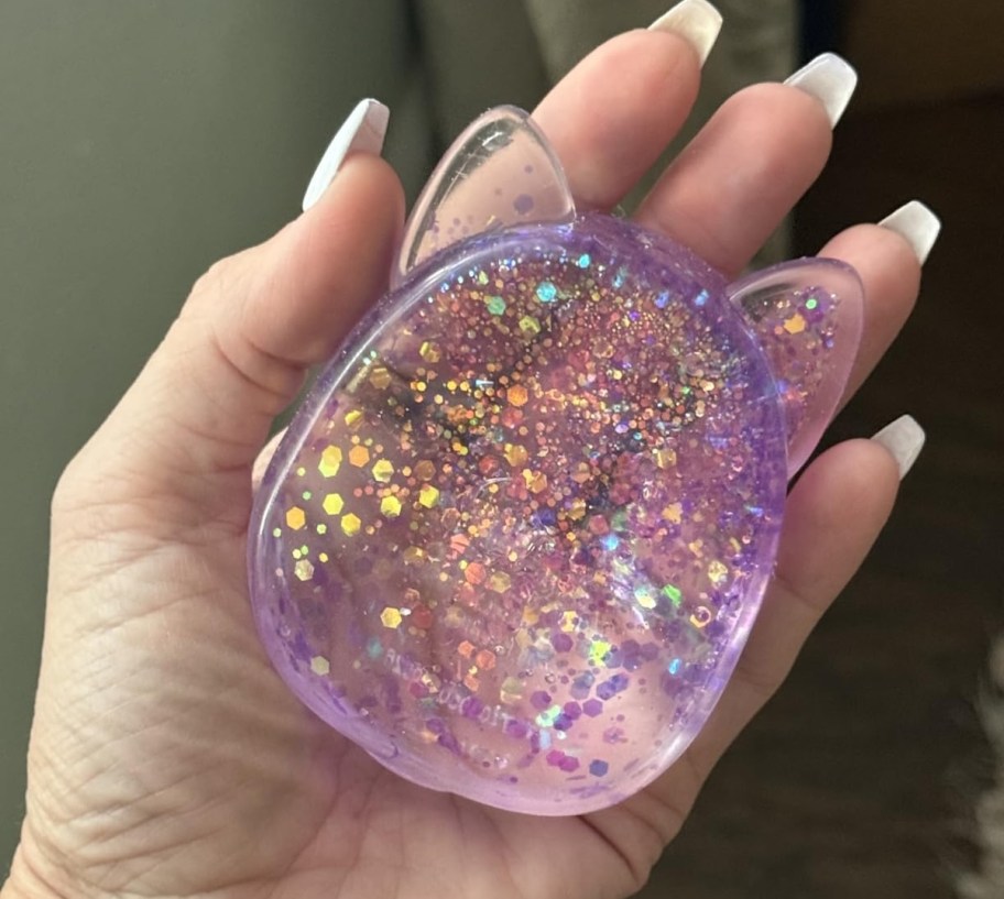 hand holding glitter squishmallow