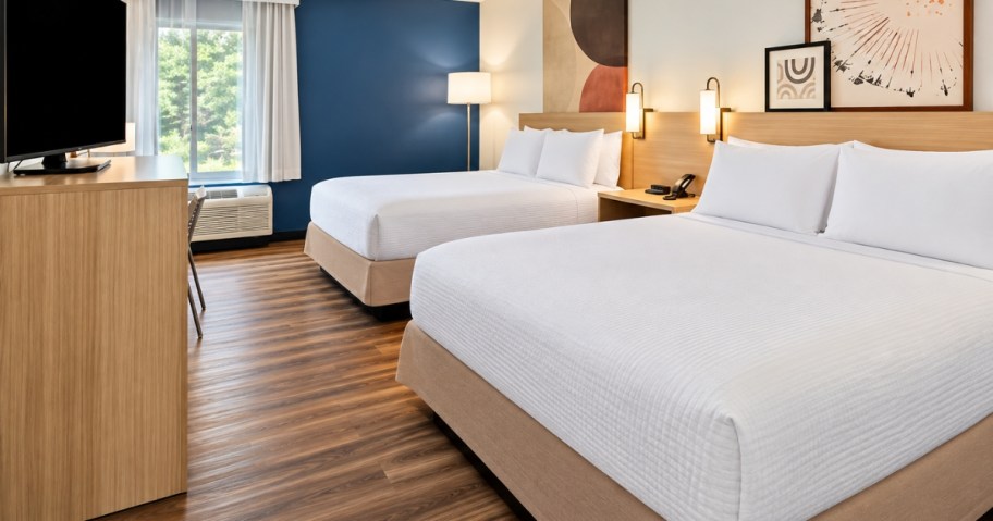 a hotel room with 2 queen beds