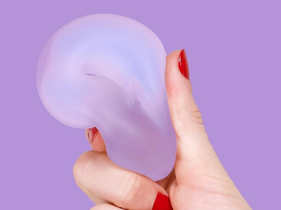hand holding a purple squishie donut