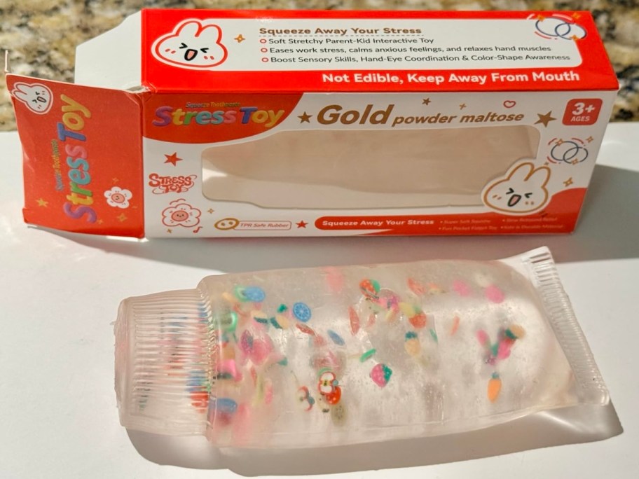 squishy toothpaste on white countertop with box