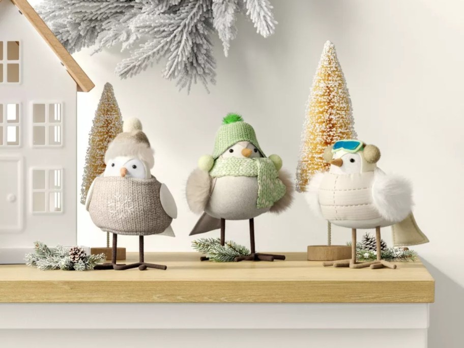 3 fabric birds on a mantle decorated for Christmas