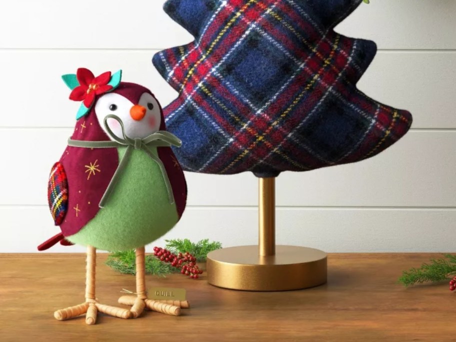 fabric bird next to a fabric Christmas tree on tabletop