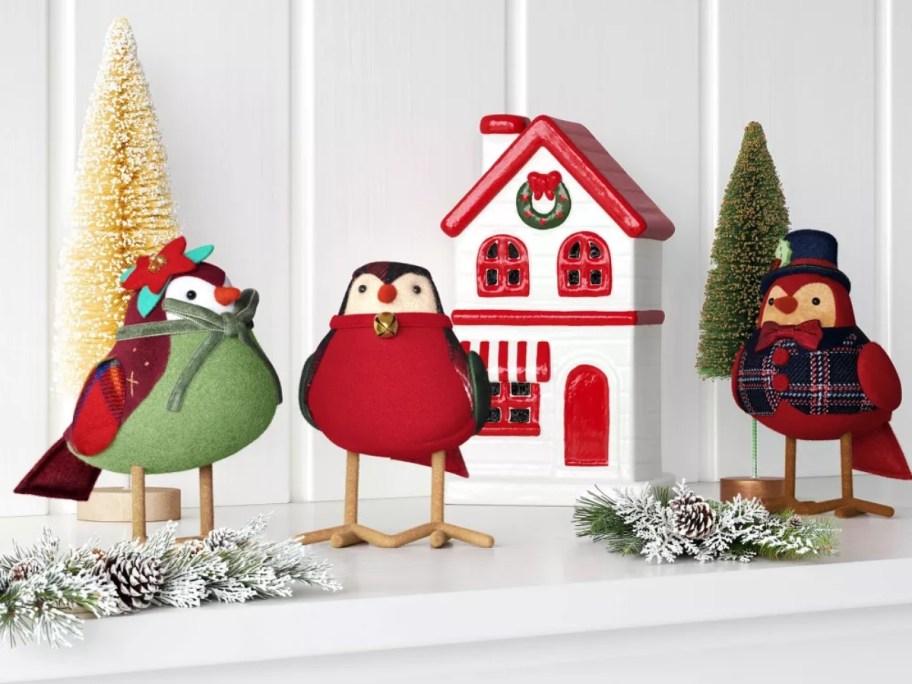 3 fabric birds on a mantle decorated for Christmas