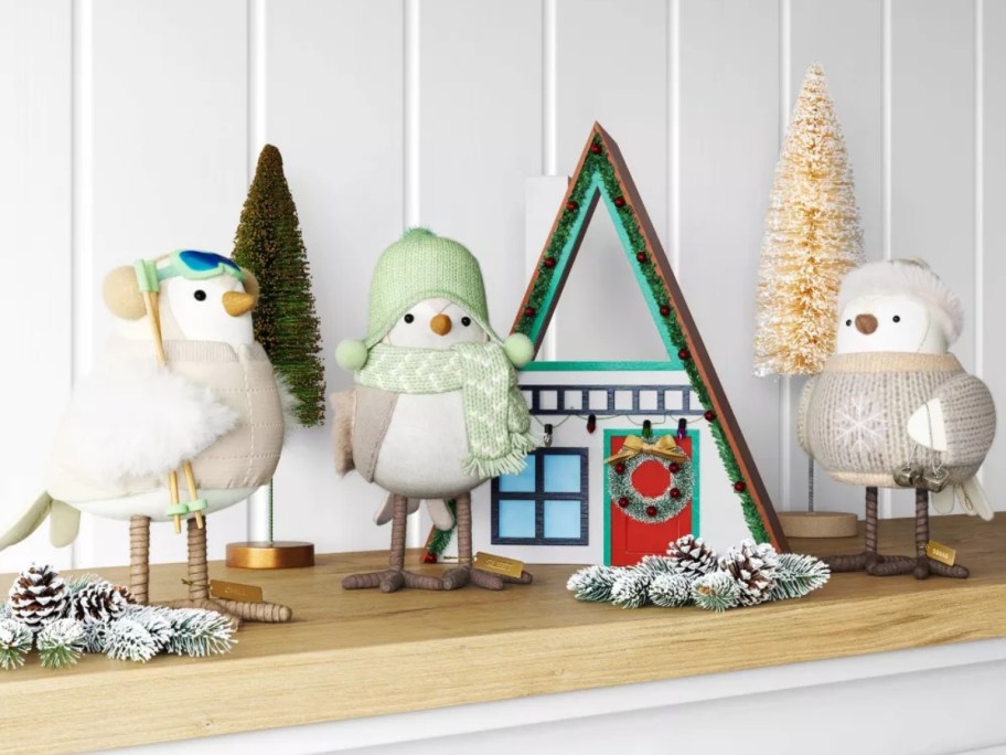 3 white fabric birds next to an apline ski tabletop display