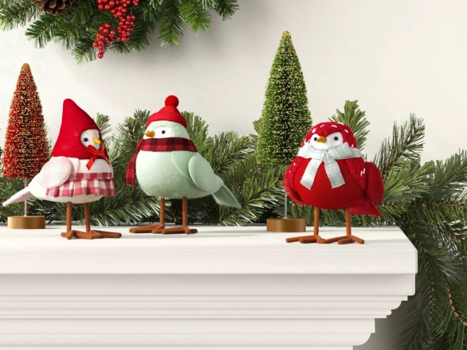 3 fabric birds on a mantle decorated for Christmas