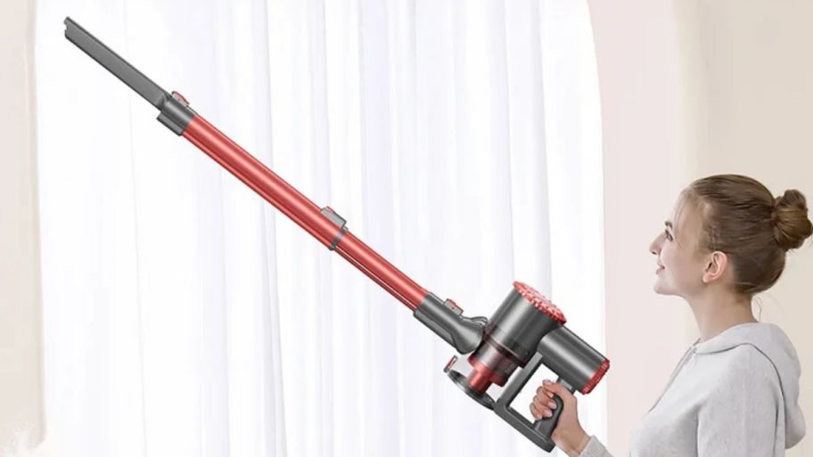 woman holding vacuum with extender