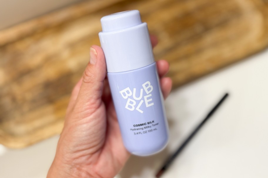 hand holding blue bubble serum