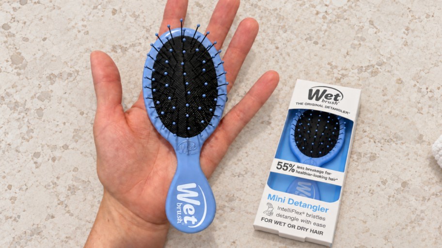 hand holding a mini detangling wet brush