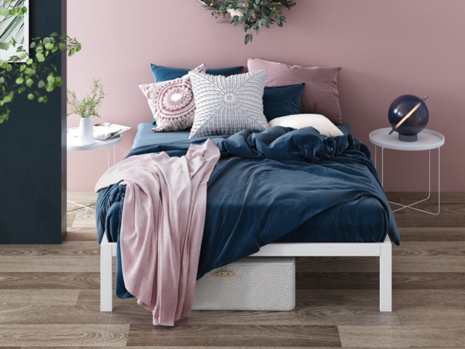 white bed with blue and pink bedding