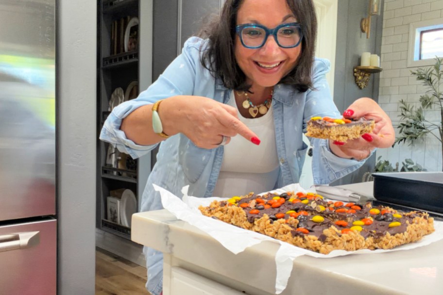 woman making a batch of oatmeal rice kudos bars
