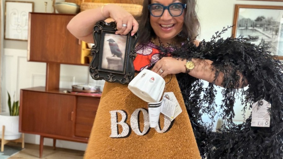 woman holding halloween decor items