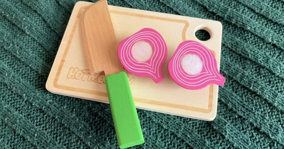 wooden toy cutting board with toy onion and toy knife