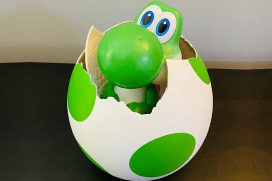 green dinosaur hatching out of egg