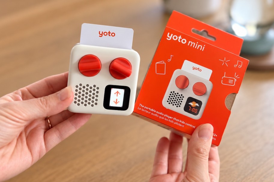 hands holding yoto mini with box