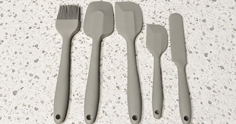 beige spatula set laying on countertop 