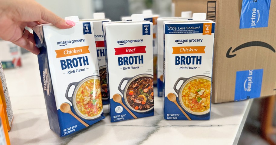Amazon Grocery Broth cartons on a counter near Amazon shipping box