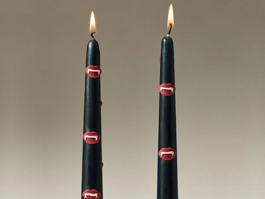 Two black taper candles with Vampire mouths on them