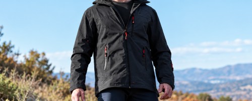 man wearing a black jacket on a hike