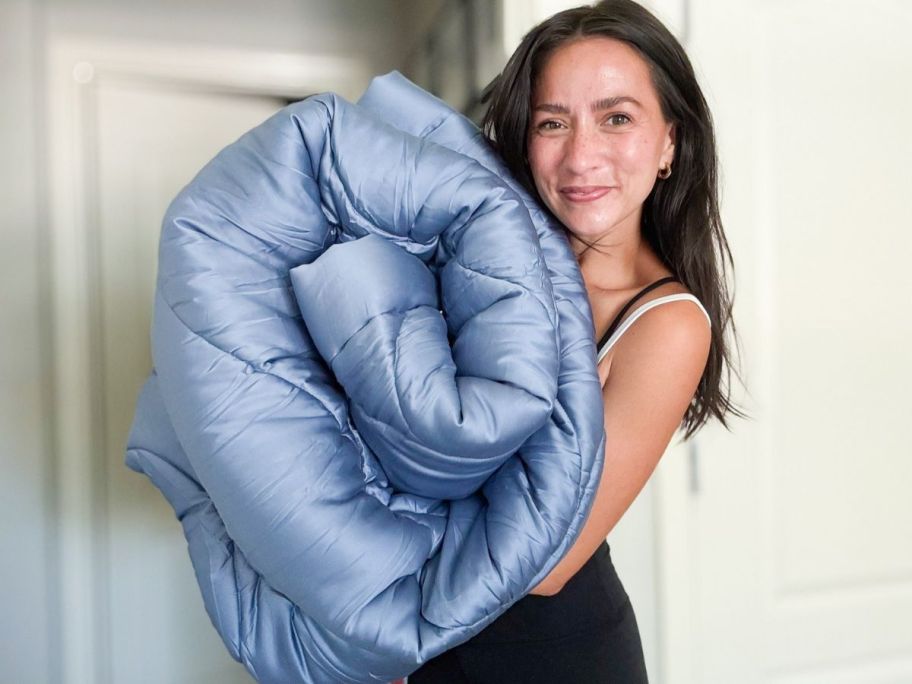 A Woman holding a Buffy Comforter