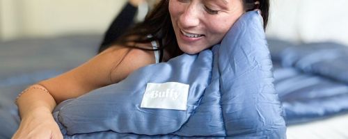 Woman snuggling with a Buffy Comforter