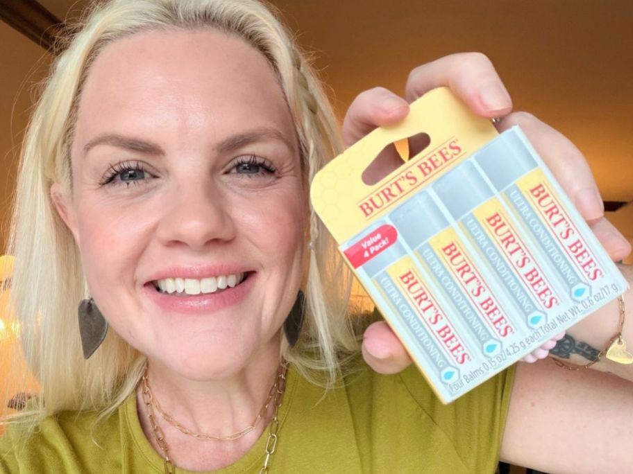 Woman holding a pack of Burt's Bees Ultra Conditioning Lip Balm 4-Count