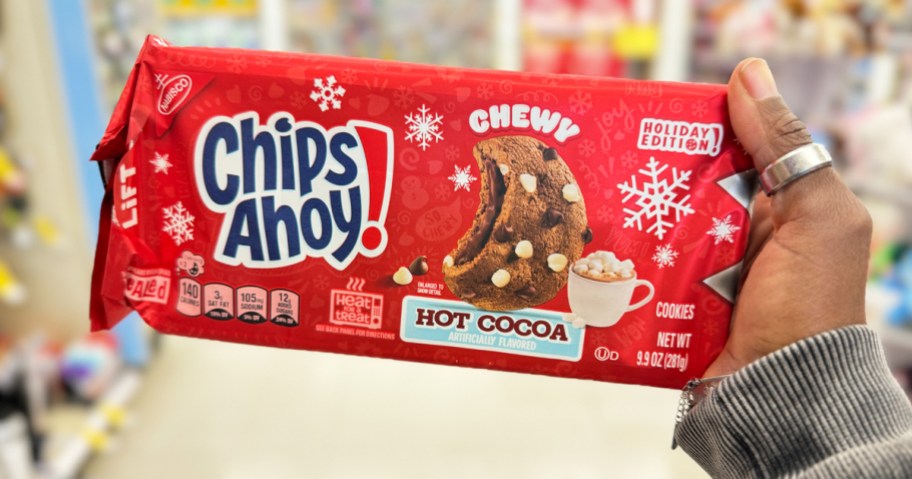 hand holding up a red pack of Chips Ahoy! Hot Cocoa Cookies in store
