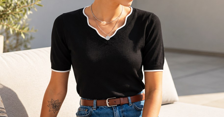 woman wearing a black short sleeve sweater