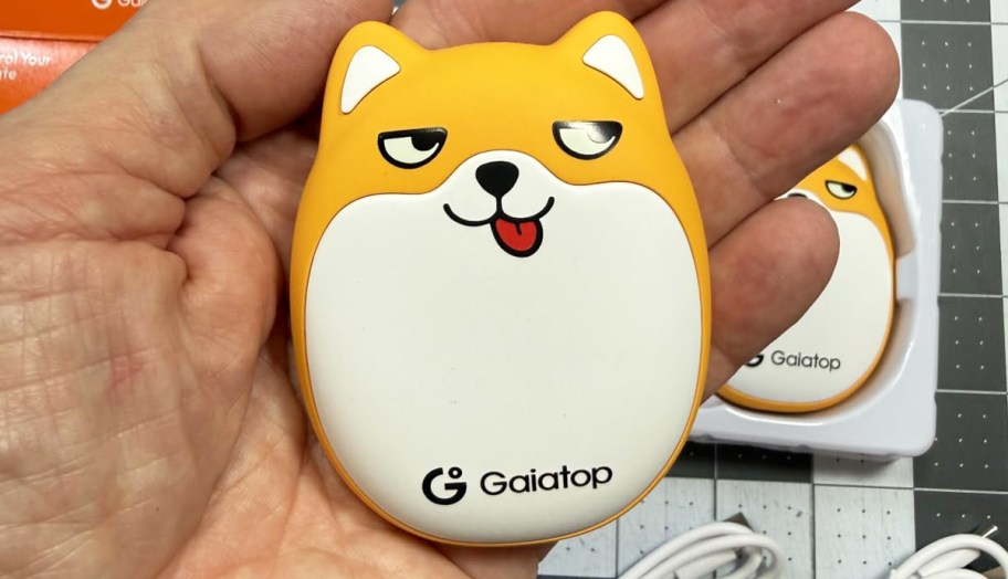 hand holding a dog shaped hand warmer