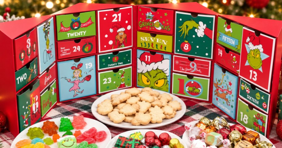 Grinch advent calendar opened up to show all 24 boxes of candies and cookies