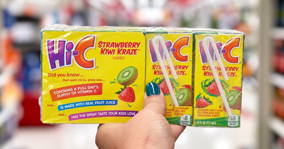 hand holding up a pack of HI-C Juice Boxes in store aisle