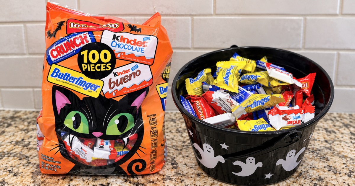 Large bag of Halloween candy next to ghost themed candy bowl filled with individual candy pieces