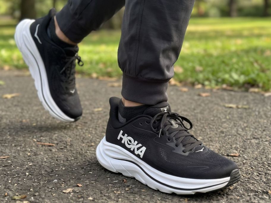 Man's feet wearing HOKA Clifton 10 running shoes