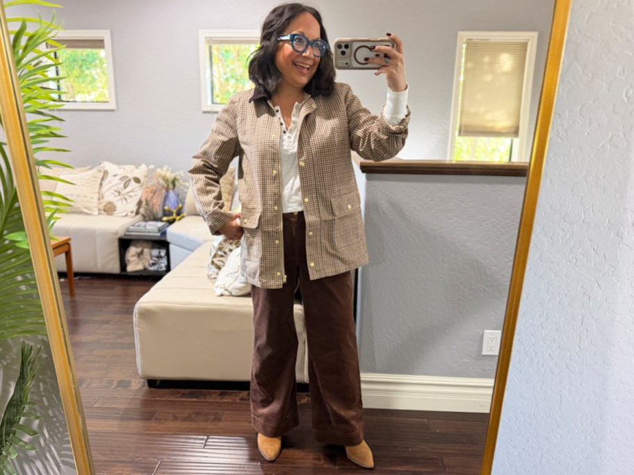 woman wearing plaid jacket and brown pants