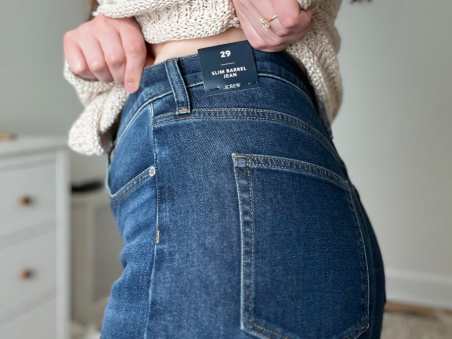 woman pulling up a pair of jeans