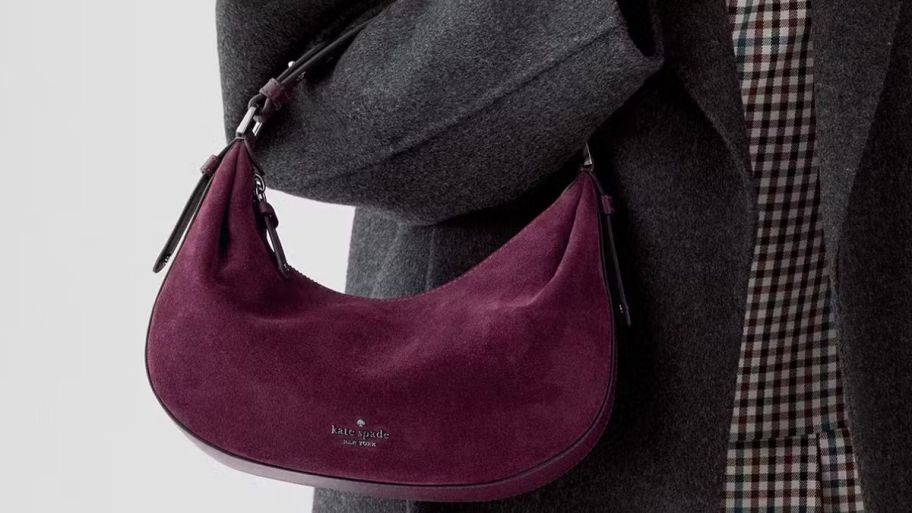 person holding a Kate spade burgundy bag